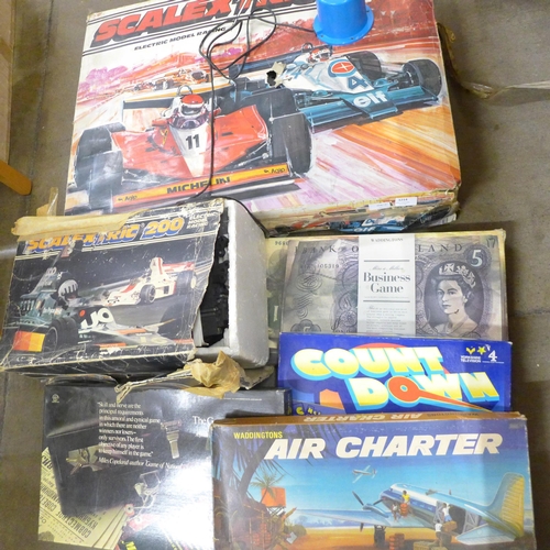 1214 - Two Scalextric sets, 500 and 200 and a collection of board games including Air Charter, The Game of ... 