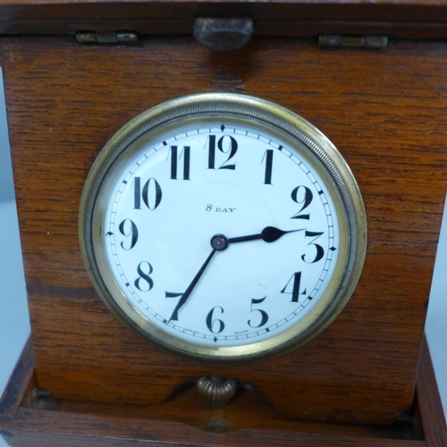 626 - A wooden cased travel clock with 8 days movement