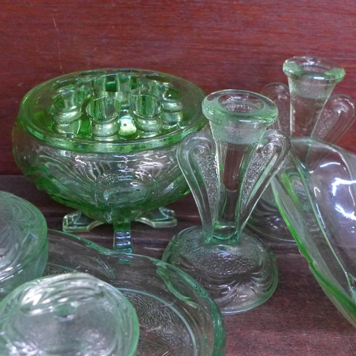 675 - A collection of uranium glass including a flower frog, dressing table set, vases, etc. **PLEASE NOTE... 