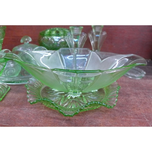 675 - A collection of uranium glass including a flower frog, dressing table set, vases, etc. **PLEASE NOTE... 