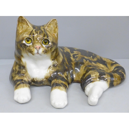 688 - A large Winstanley Tabby cat, signed to base, 35cm