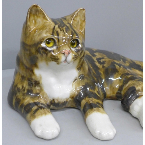 688 - A large Winstanley Tabby cat, signed to base, 35cm