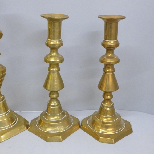 702 - Three pairs of brass candlesticks