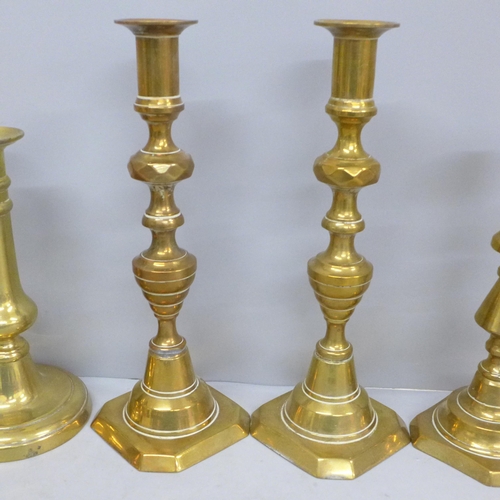 702 - Three pairs of brass candlesticks