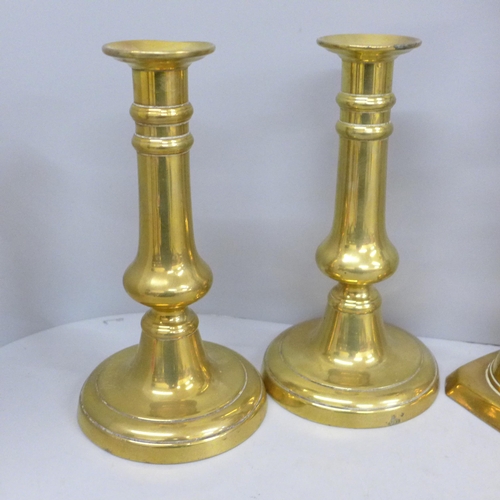 702 - Three pairs of brass candlesticks