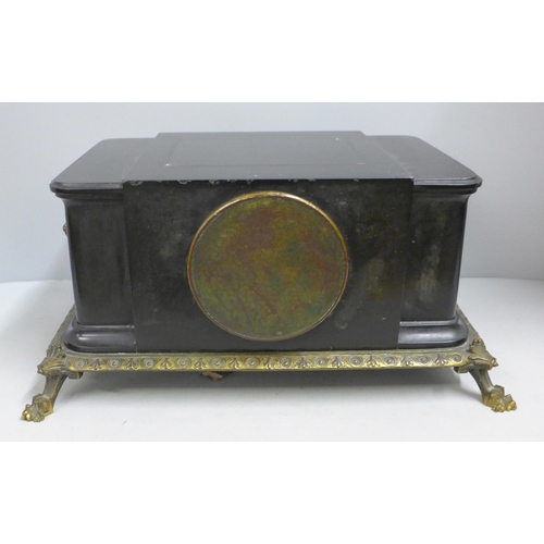 786 - A 19th Century French belge-noir mantel clock on a cast metal frame with patinated bronze sculpture ... 