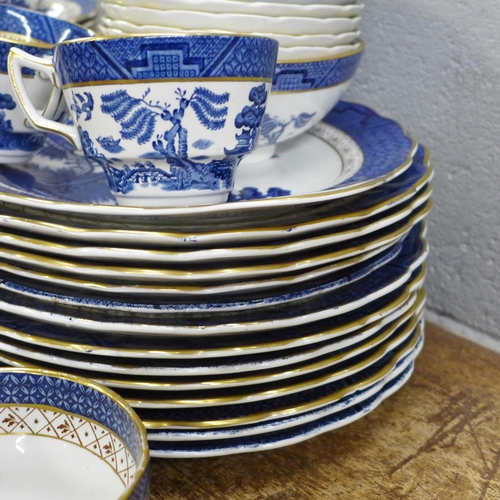 796 - Thirteen Real Old Willow plates marked A8025 Booths; a serving plate, six cups and saucers, a milk j... 