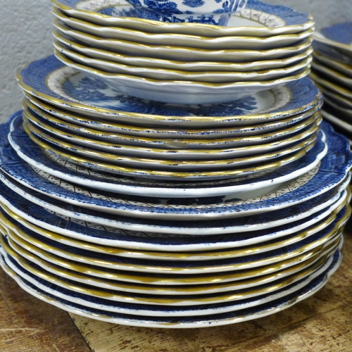 796 - Thirteen Real Old Willow plates marked A8025 Booths; a serving plate, six cups and saucers, a milk j... 