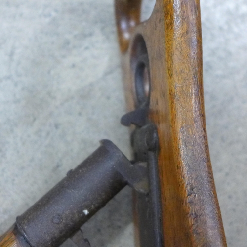 800 - An early 20th Century wooden shooting stick with carved shooting emblem in the seat