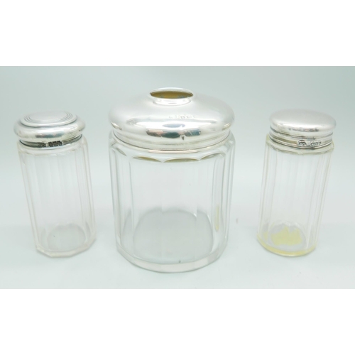 825 - Three silver topped glass jars, 32g