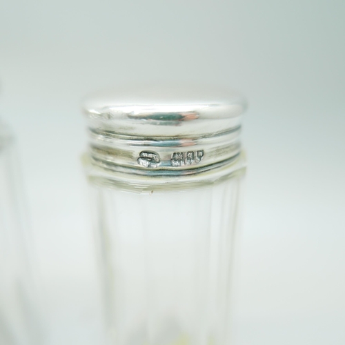 825 - Three silver topped glass jars, 32g