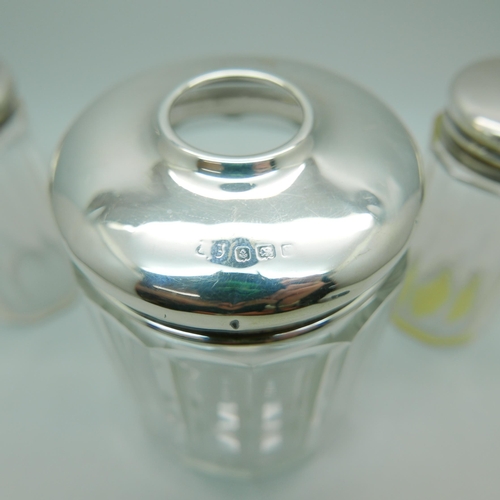 825 - Three silver topped glass jars, 32g