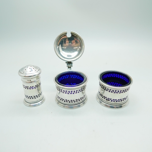 826 - A three piece silver cruet set with blue glass liners, Birmingham 1931, 58g