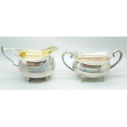 832 - A 19th Century silver cream jug and an early 20th Century silver sugar bowl, worn Birmingham and Che... 