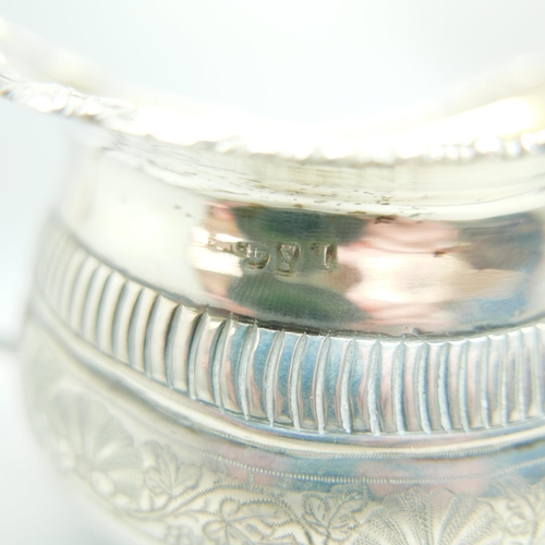 832 - A 19th Century silver cream jug and an early 20th Century silver sugar bowl, worn Birmingham and Che... 