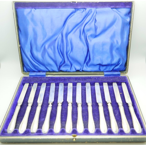 835 - A cased set of twelve dessert knives, with silver covered handles