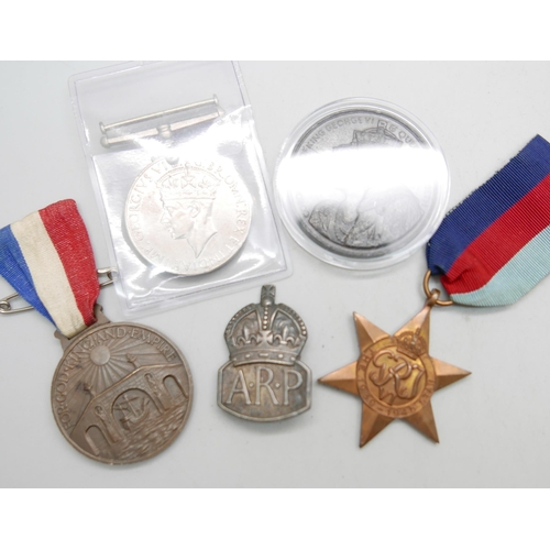 894 - Two WWII medals, A.R.P. badge, Coronation medal and one other