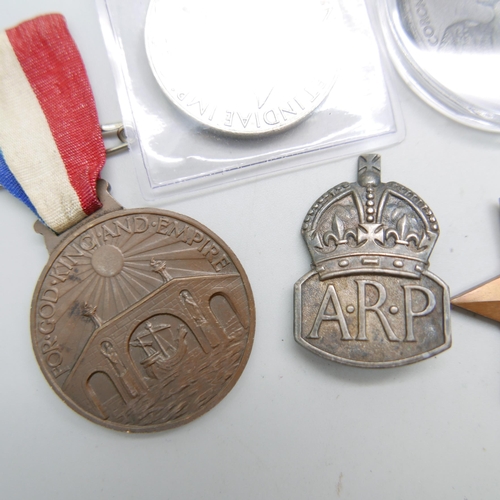 894 - Two WWII medals, A.R.P. badge, Coronation medal and one other