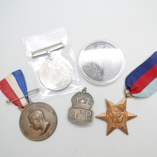 894 - Two WWII medals, A.R.P. badge, Coronation medal and one other