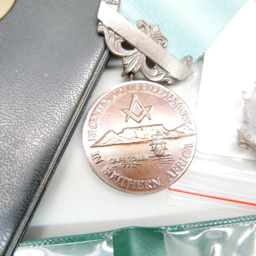 916 - A collection of South African cap badges, buttons and pips and a Freemasons medallion