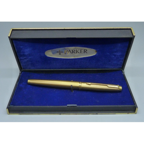 928 - A gold plated Parker fountain pen with a 14ct gold nib, boxed