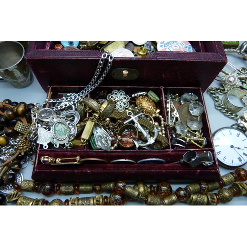 933 - Costume jewellery, badges, etc., and a fob watch marked fine silver