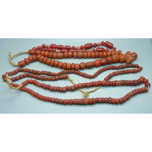 934 - Four coral coloured necklaces