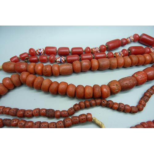 934 - Four coral coloured necklaces