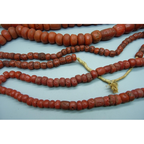 934 - Four coral coloured necklaces