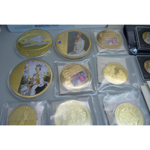 935 - A collection of gold plated commemorative coins and medallions including Concorde with authenticity ... 