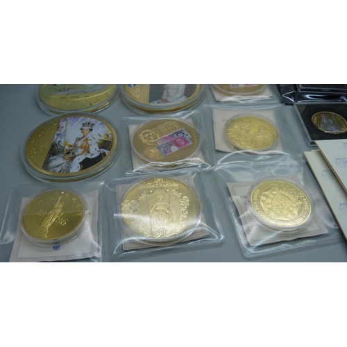 935 - A collection of gold plated commemorative coins and medallions including Concorde with authenticity ... 