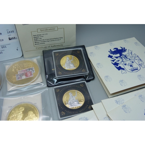 935 - A collection of gold plated commemorative coins and medallions including Concorde with authenticity ... 