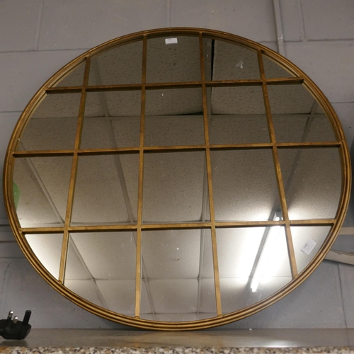 1485 - A gold circular window mirror