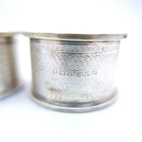 869 - A boxed pair of silver napkin rings, 27g