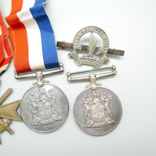 898 - Two South African For War Services Medals, a German Cross medal and three badges