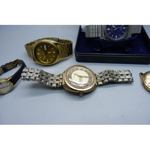 922 - Watches including a Seiko 5 automatic, a Seiko quartz day/date and a lady's Omega