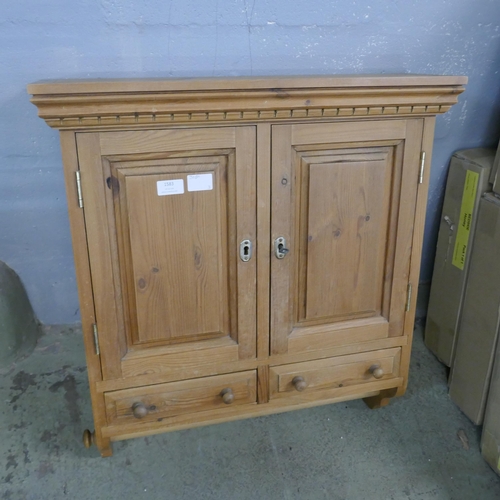 1583 - A pine bathroom/kitchen cabinet with towel rail