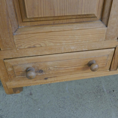 1583 - A pine bathroom/kitchen cabinet with towel rail