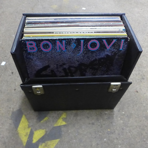 2109 - An assortment of 30 rock LP records in a protective case including Bon Jovi, Meatloaf, Dire Straits,... 