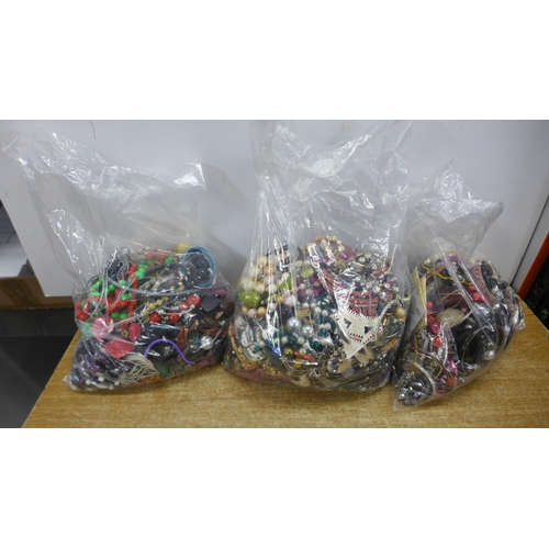 2128 - Three large bags of costume jewellery