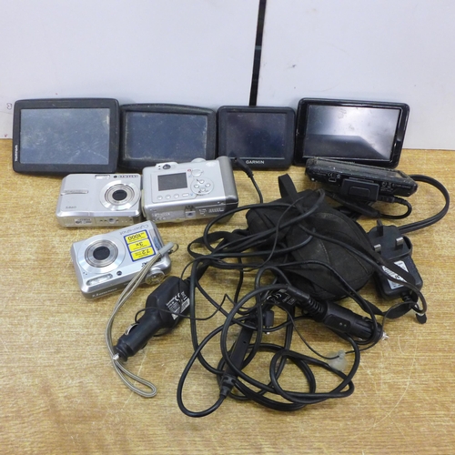 2138 - Two Tom Tom sat nav systems, two Garmin sat nav systems and a collection of older digital cameras in... 