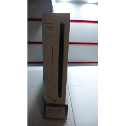 2141 - A Nintendo Wii console with cables and Wii fit board with silicone sleeve, two Nintendo Wii wireless... 