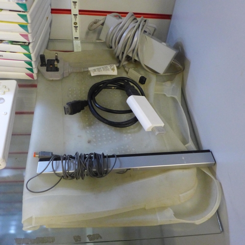 2141 - A Nintendo Wii console with cables and Wii fit board with silicone sleeve, two Nintendo Wii wireless... 