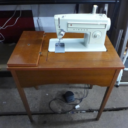 2144 - A Singer 509 240v sewing machine with pedal in an integrated work table