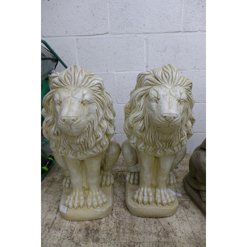 2272 - A pair of sandstone effect concrete lion statues