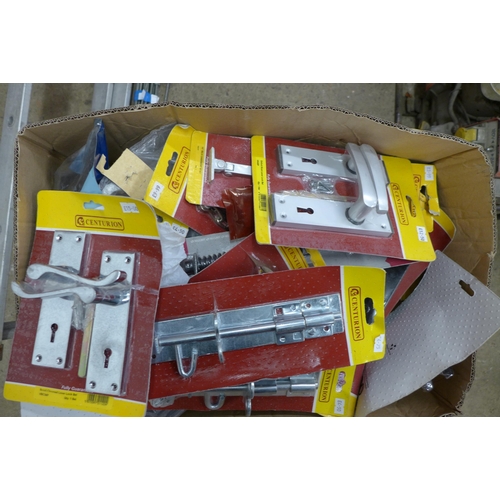 2361 - A box of door furniture, most sealed in packets, handles, knobs, etc.