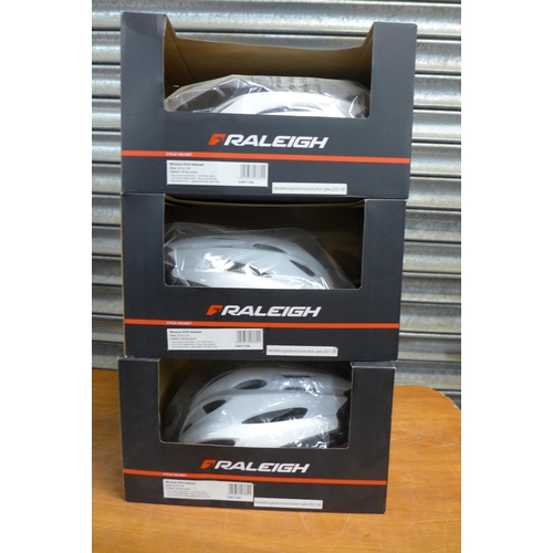 2391 - Eight Raleigh Mission Evo cycle helmets in white and pink and white and mint - all sized 58 to 61cm