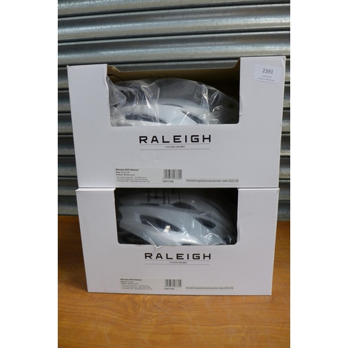 2391 - Eight Raleigh Mission Evo cycle helmets in white and pink and white and mint - all sized 58 to 61cm