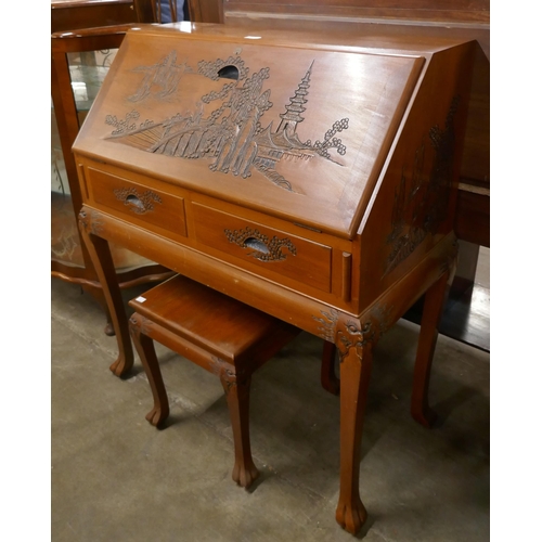 114 - An Oriental carved camphorwood bureau and an occasional table