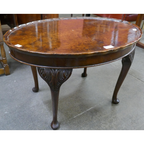 115 - A Queen Anne style burr walnut oval coffee table